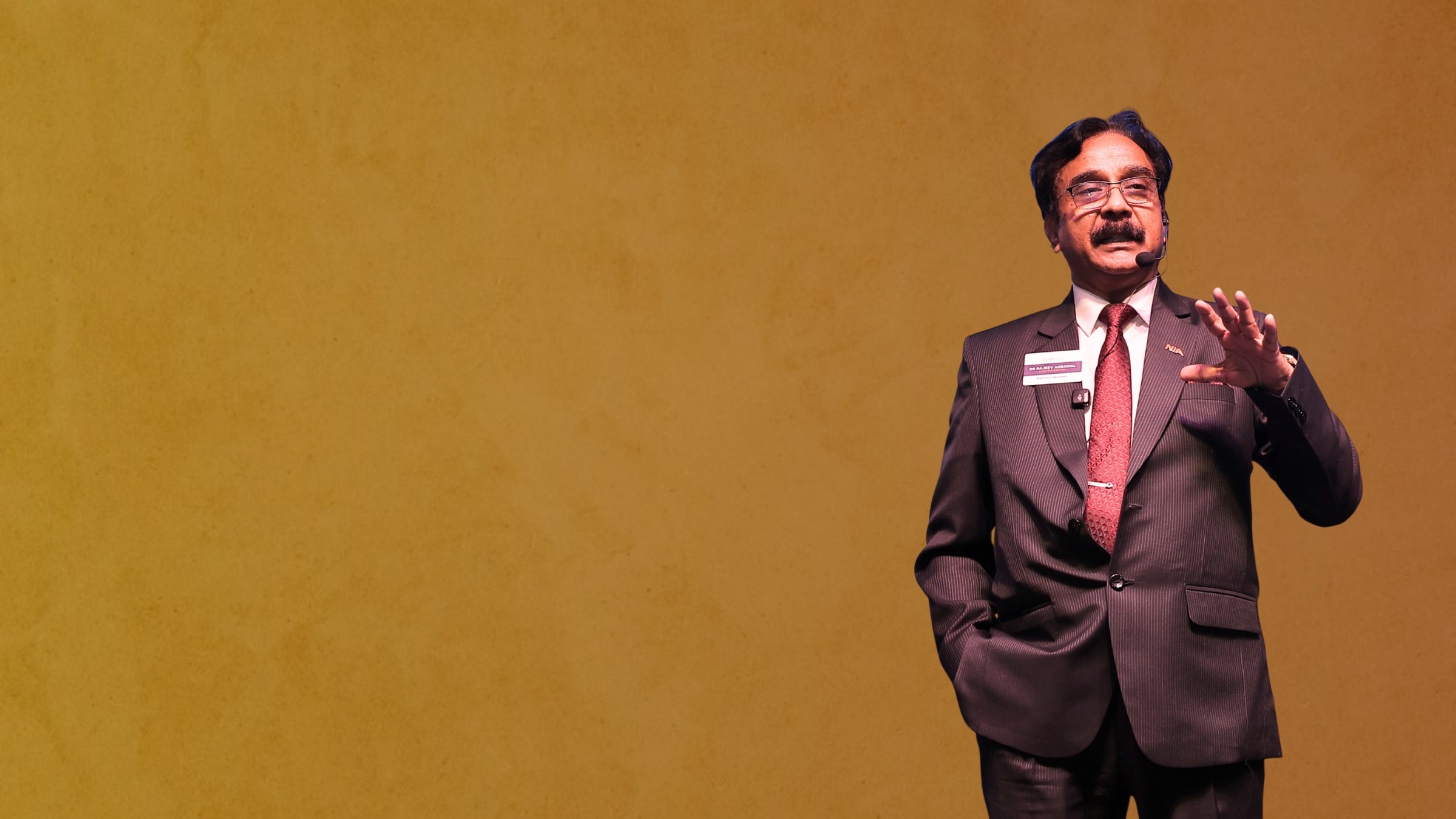 Dr. Rajeev Agrawal speaking on stage